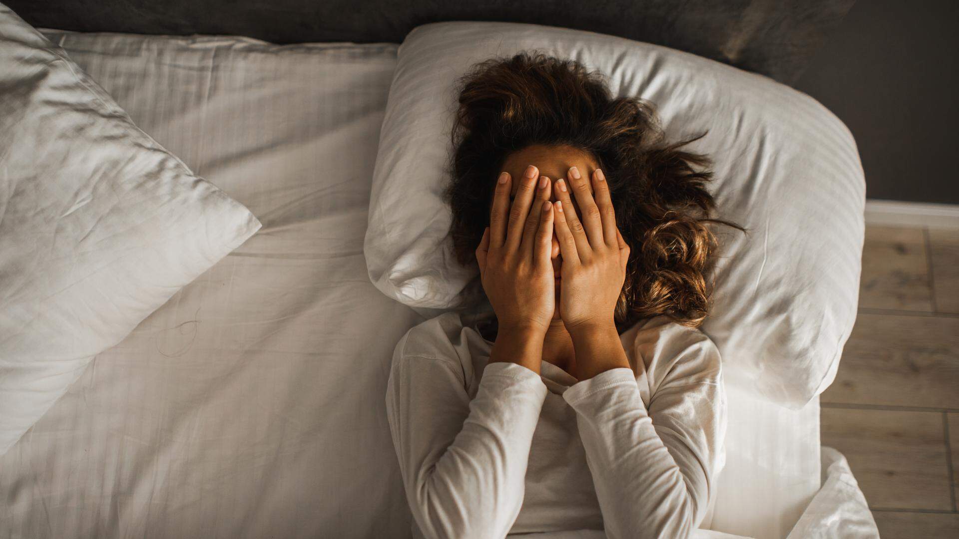 Sad and lonely girl in bedroom. Insomnia and psychological issues. Breakup with boyfriend. Conceptual of bad condition of broken hearted, sadness, loneliness or depress woman.