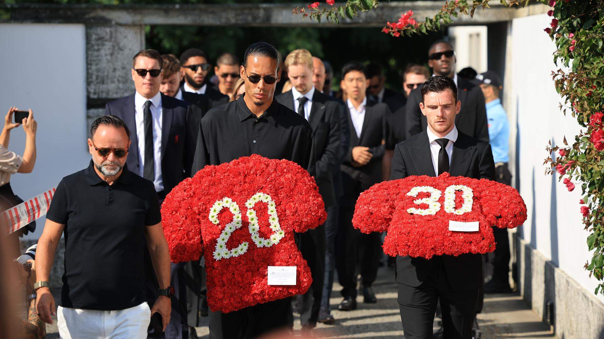 epa12217257 Liverpool players Virgil van Dijk (C) and Andrew Robertson (R) carry floral tributes for the funeral of late Portugal's player Diogo Jota and his brother Andre Silva, in Gondomar, Portugal, 05 July 2025. Jota and his brother died in a car accident in Spain on 03 July 2025.  EPA/ESTELA SILVA